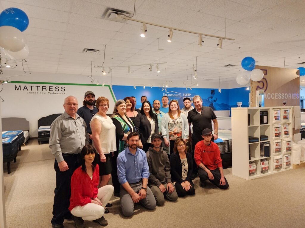 Renaud's BrandSource Home Furnishings' staff gathers during the Grand Opening of their new BrandSource Sleep department.